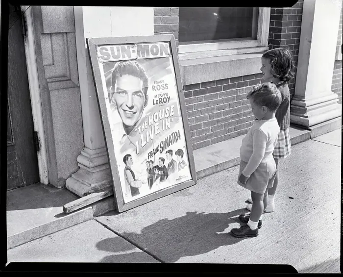 Framed Print : Two Children Stand in Front of Theater Framed Print : Two Children Stand in Front of Theater