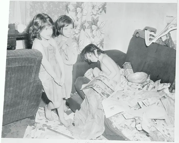 Framed Print : Children Standing by a Junk Strewn Couch