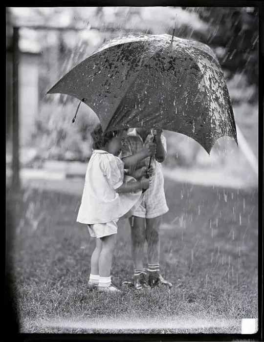 Framed Print : Children Under Umbrella During Rainstorm Framed Print : Children Under Umbrella During Rainstorm