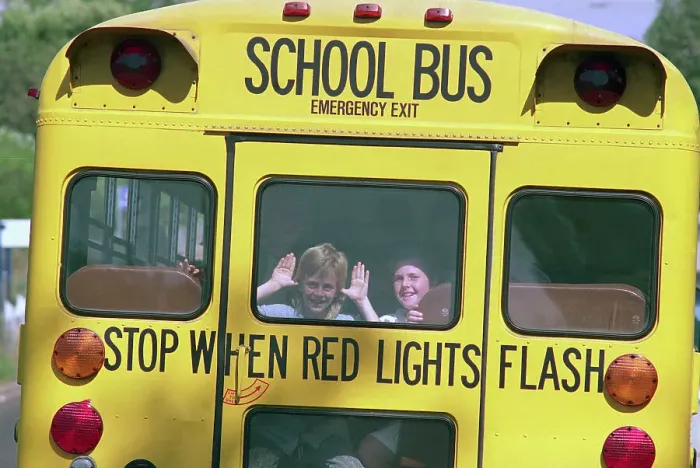 Framed Print : Children Waving from Back of School Bus Framed Print : Children Waving from Back of School Bus