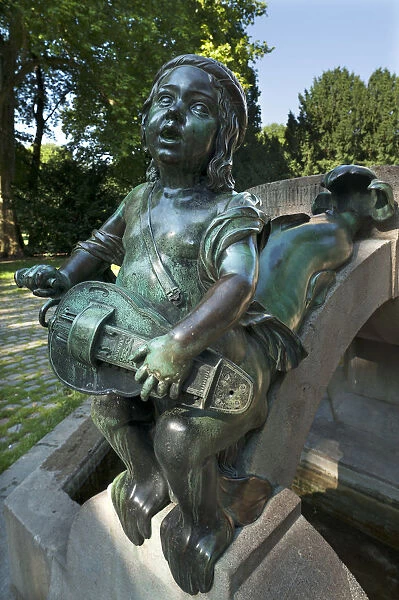 Childs sculpture with musical instrument and fish fin on Minnesangerbrunnen fountain, art nouveau, 1905, Rosenaupark, Nuremberg, Middle Franconia, Bavaria, Germany