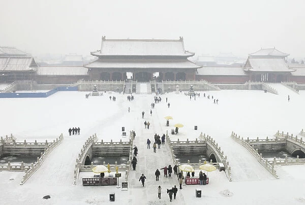 China, Beijing, Forbidden City, winter snow covering courtyard and buildings