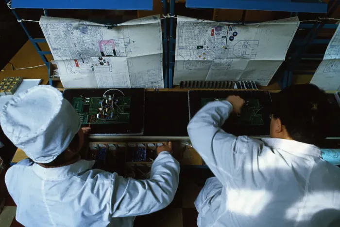 Framed Print : Chinese Workers with Multi Meter Device