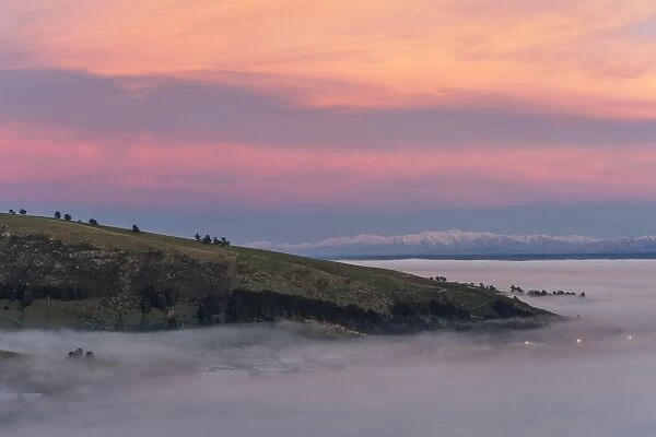 Christchurch in the fog before sunrise, in front of the Southern Alps, South Island, New Zealand