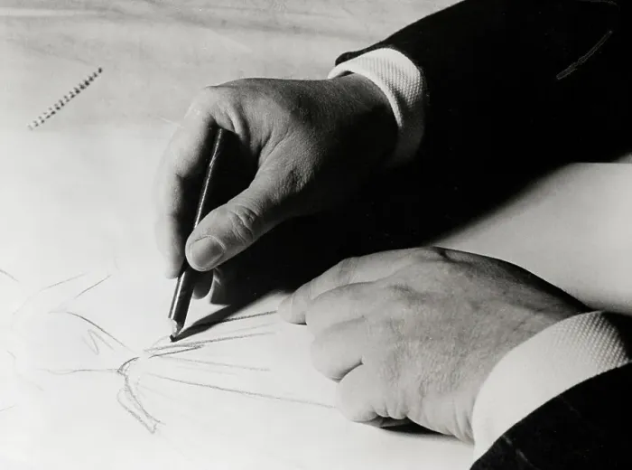 Framed Print : Christian Dior Sketching a Dress
