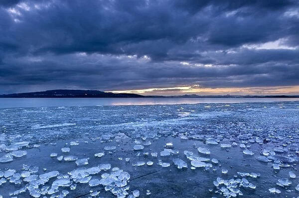 Chunks of ice lying on icy surface on the shore of Reichenau Island, Baden-Wuerttemberg, Germany, Europe