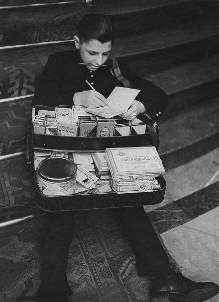 Cigarette Boy. A cigarette boy with his tray of tobacco products at a cinema or theatre