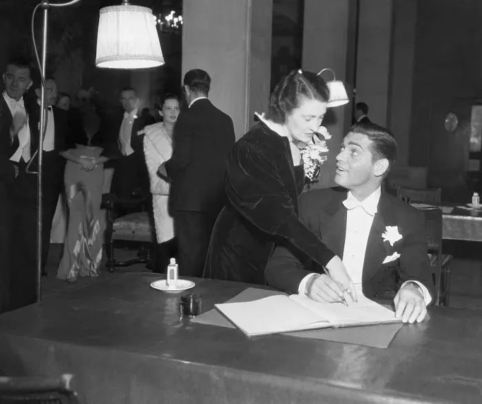 Framed Print : Clark Gable Signing Book with Wife Framed Print : Clark Gable Signing Book with Wife