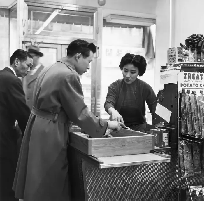 Framed Print : Clerk at Counter Checks Customer and Goods Framed Print : Clerk at Counter Checks Customer and Goods