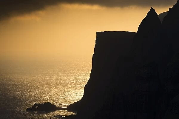 Cliffs and sea in evening light, near Lopra, Suouroy, Faroe Islands, Denmark