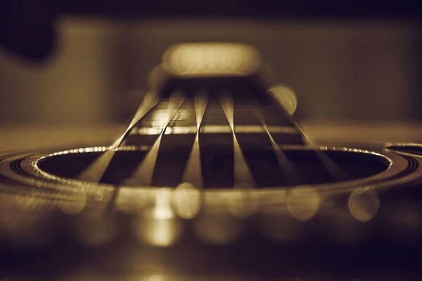 Close up of six string acoustic guitar
