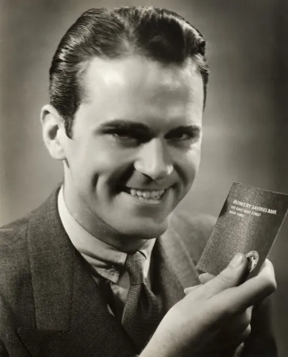 Framed Print : Close-up of smiling man with bank passbook Framed Print : Close-up of smiling man with bank passbook