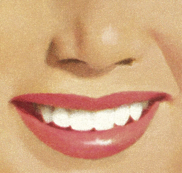 Close-up of a womans smile with red lips and white teeth