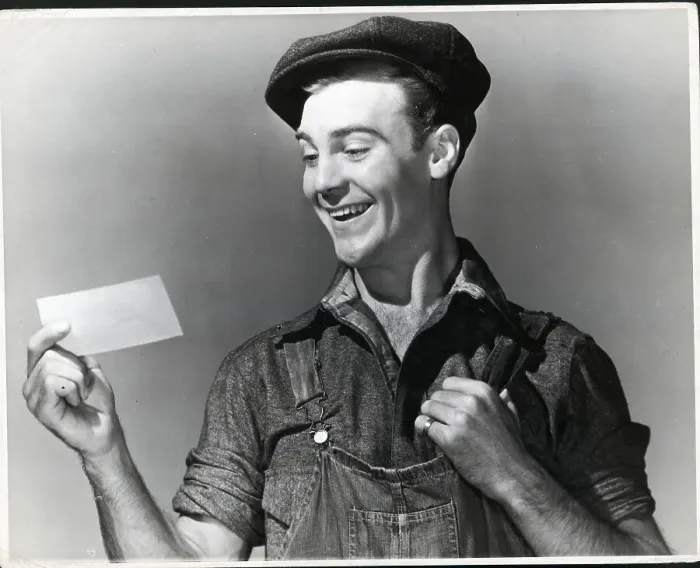 Framed Print : Close-Up Working Man Smiling At Paper Framed Print : Close-Up Working Man Smiling At Paper