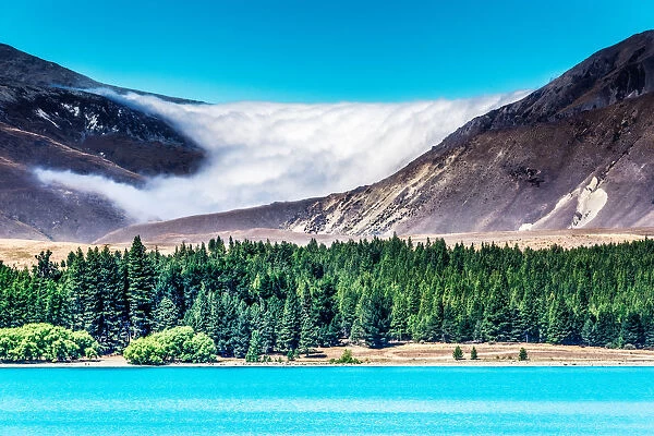 A cloud bank settles in on the mountains above Lake Tekapo, New Zealand