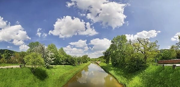 Clouds over the old Ludwig Canal or Ludwig-Donau-Main-Kanal with flowering fruit trees, Naturpark Altmuehltal nature forest, Bavaria, Germany, Europe