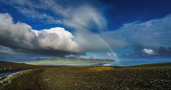 Clouds and rainbow over the seashore, Iceland