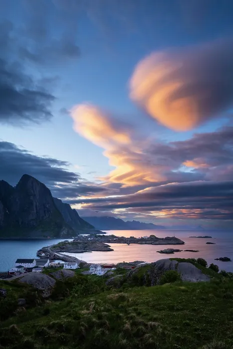 Framed Print : Cloudy landscape. The villages of Olenilsoy, Toppoya (Toppoy) and Hamnoy as well as the mountain Festhaeltinden. View over the sea towards Flakstadoya and Vestvagoya. Several coloured lenticular clouds (lenticularis) in the blue sky