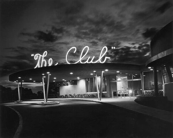 The Club. Exterior view of The Club, a private nightclub with a neon sign on its roof