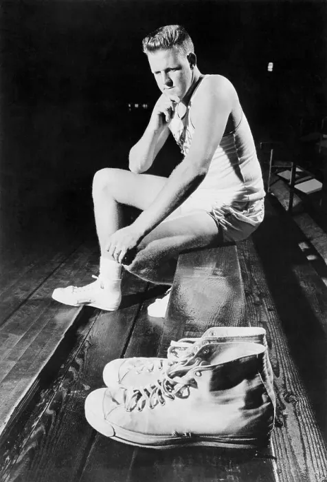 Framed Print : Clyde Lovelette Looking at a Pair of Shoes