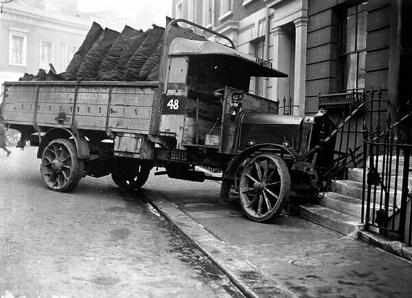 Coal Truck Crash. December 1923: A lorry delivering coal, which has skidded off the road