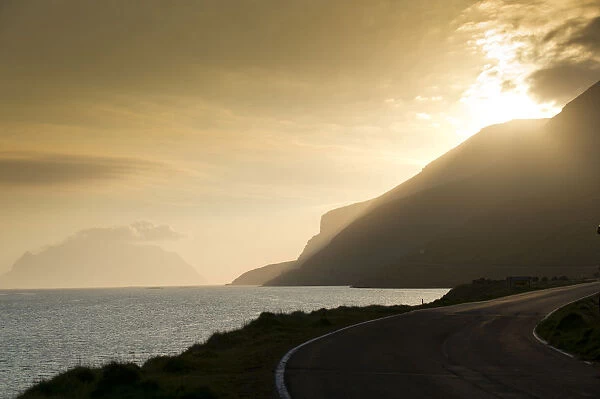 Coastal road, sea and clouds, evening mood, backlighting, Mykines Island at the rear, Mykines, Faroe Islands, Denmark