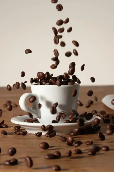 Framed Print : Coffee beans being poured into a cup Framed Print : Coffee beans being poured into a cup