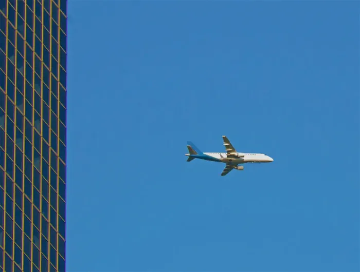 Framed Print : Flyby. A color photograph of a commercial passenger jet flying past a commercial Framed Print : Flyby. A color photograph of a commercial passenger jet flying past a commercial