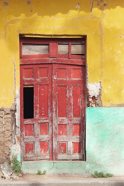 Colorful facade and red door at old colonial house in Granada, Nicaragua