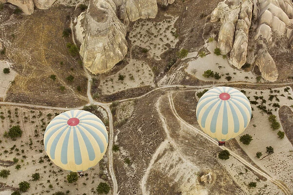 Colorful hot air balloons flying over Red valley at Cappadocia, Anatolia, Turkey. Volcanic mountains in Goreme national park
