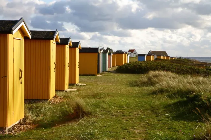 Framed Print : Colorful huts in grassy field Framed Print : Colorful huts in grassy field
