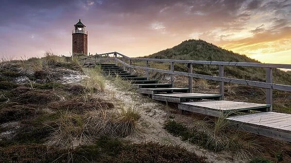 Colourful sunset behind the smallest lighthouse, the Quermarkenfeuer, on the North Frisian island of Sylt, Germany