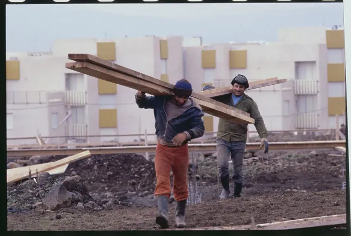 Framed Print : Construction Workers Carrying Railing near Complexes