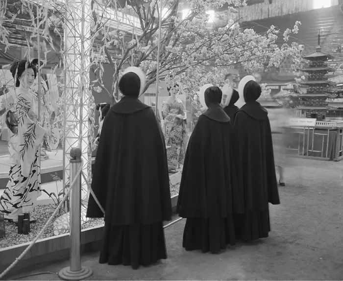 Framed Print : Contrast. Four Catholic nuns, dressed in their somber black habits, study the gay Framed Print : Contrast. Four Catholic nuns, dressed in their somber black habits, study the gay