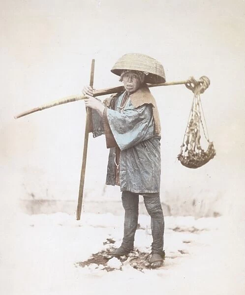 Coolie. A Japanese coolie or unskilled labourer carrying a rod of bamboo, circa 1865