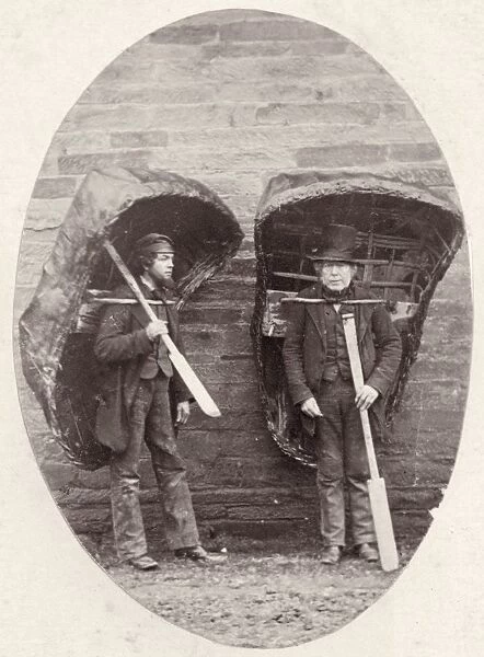 Coracles. 1856: Two men carrying their coracles - wicker boats covered