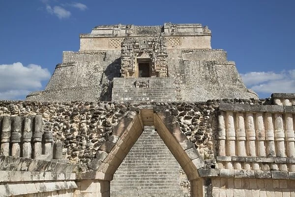 Corbelled Arch (foreground), Pyramid of the Magician (background), Uxmal Mayan archaeological site