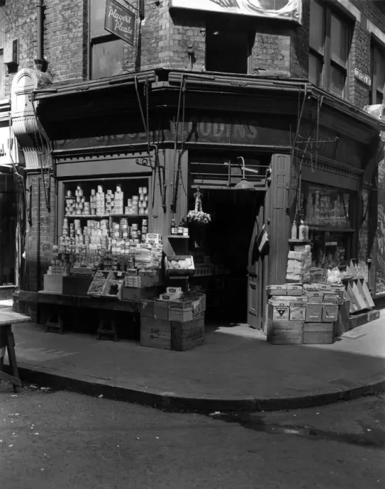 Framed Print : The Corner Shop; : A London grocers with goods on display outside Framed Print : The Corner Shop; : A London grocers with goods on display outside