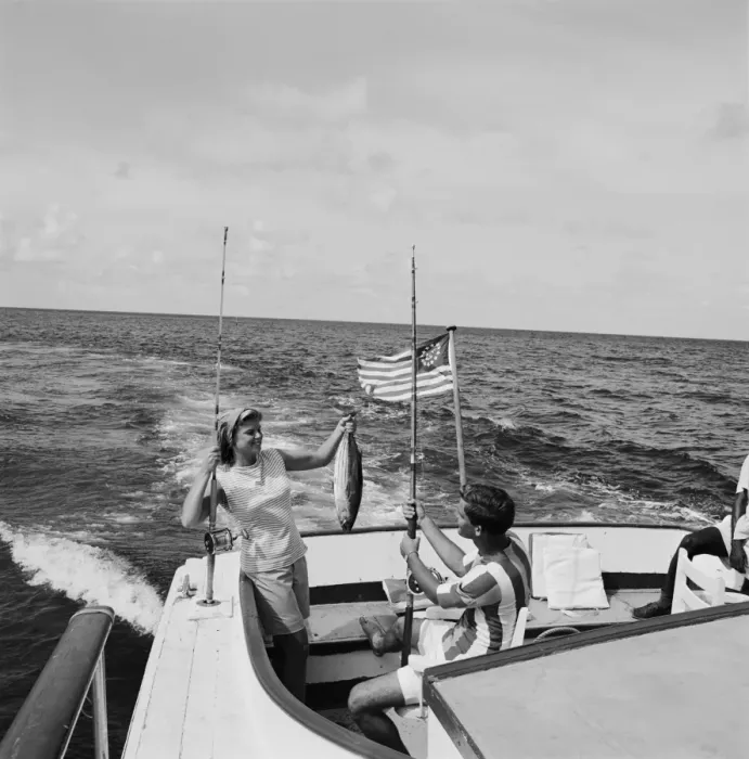 Framed Print : Couple in boat holding fish, smiling Framed Print : Couple in boat holding fish, smiling