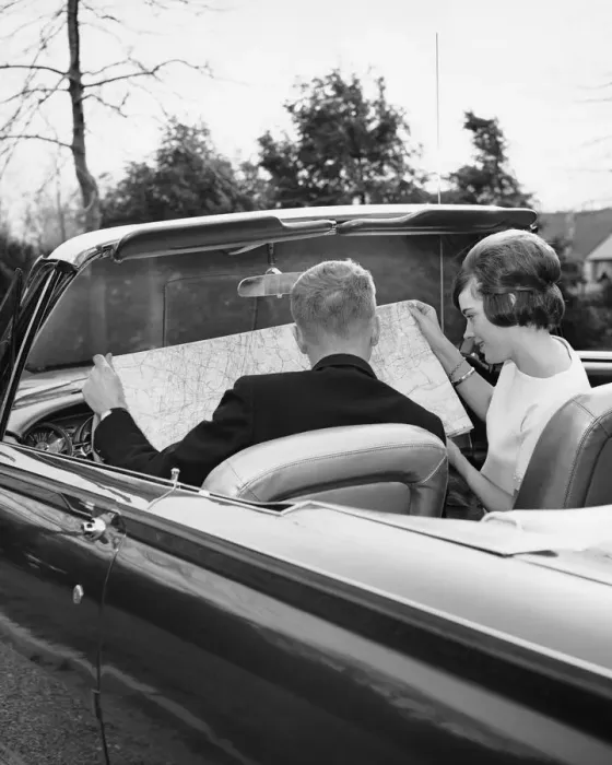 Framed Print : Couple in convertible looking at roadmap Framed Print : Couple in convertible looking at roadmap