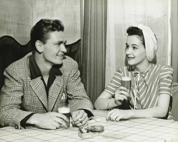 Framed Print : Couple drinking beer at bar table, (B&W) Framed Print : Couple drinking beer at bar table, (B&W)