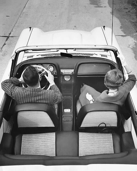 Couple driving in convertible