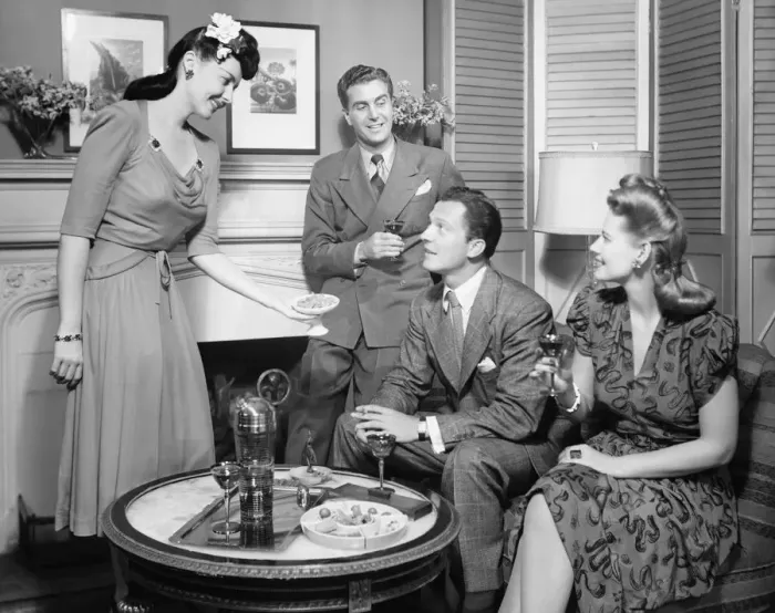 Framed Print : Couple entertaining friends (B&W) Framed Print : Couple entertaining friends (B&W)