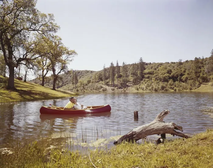 Framed Print : Couple fishing from canoe in lake Framed Print : Couple fishing from canoe in lake