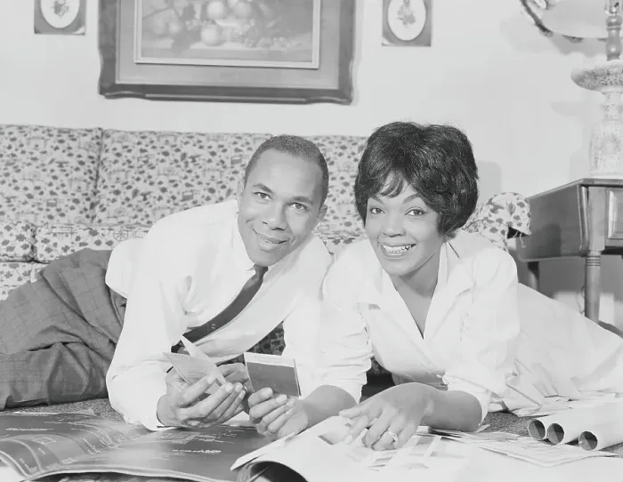 Framed Print : Couple going over house plans and color charts, smiling, portrait Framed Print : Couple going over house plans and color charts, smiling, portrait