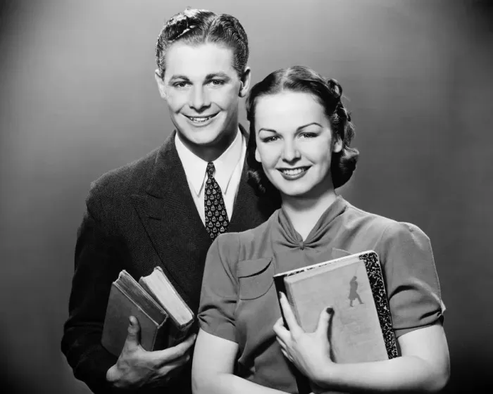 Framed Print : Couple holding books, posing in studio, (B&W), portrait Framed Print : Couple holding books, posing in studio, (B&W), portrait