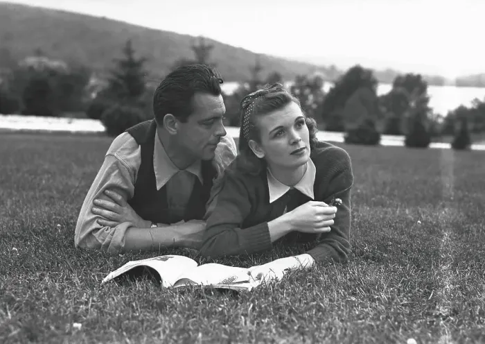 Framed Print : Couple with magazine, lying on grass, (B&W) Framed Print : Couple with magazine, lying on grass, (B&W)