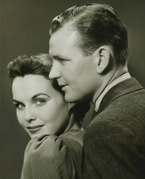 Couple posing in studio, (B&W), close-up, portrait