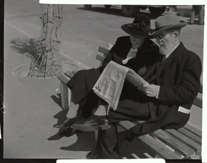 Framed Print : Couple Reading Newspaper Together on Bench Framed Print : Couple Reading Newspaper Together on Bench