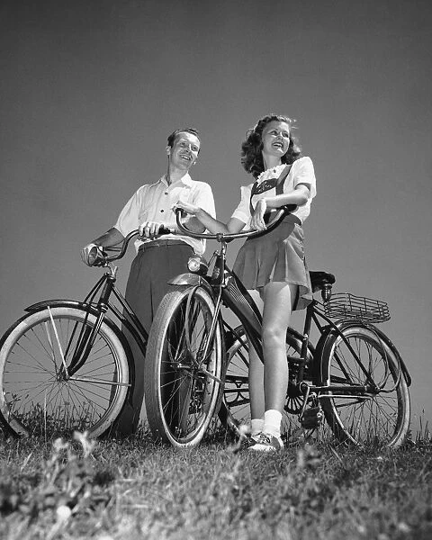 Couple standing with bicycles